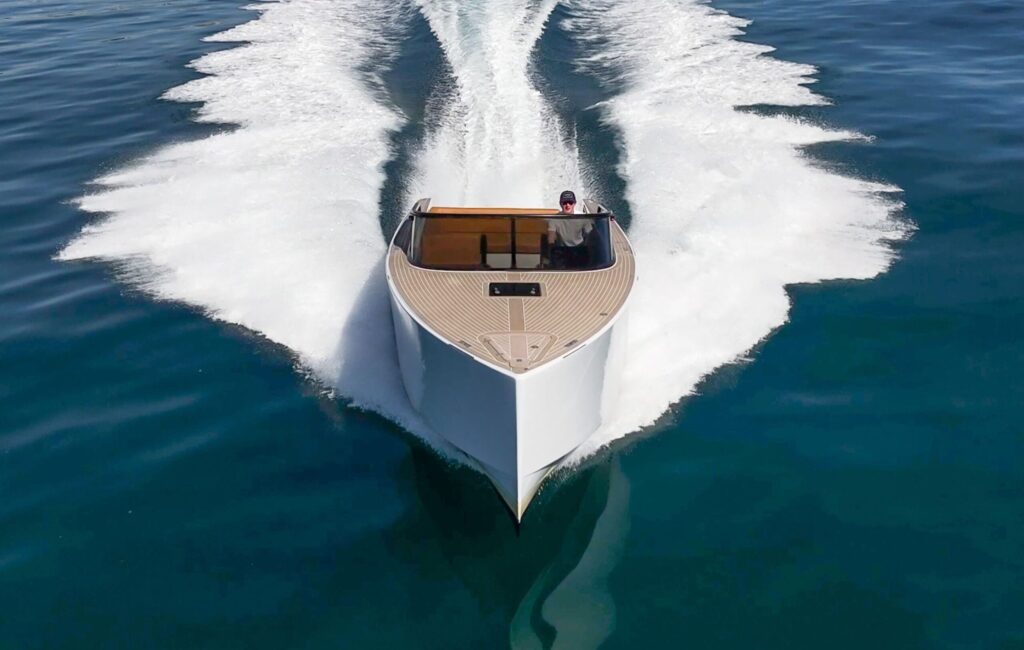 Day boat running head on with a clean bow wave