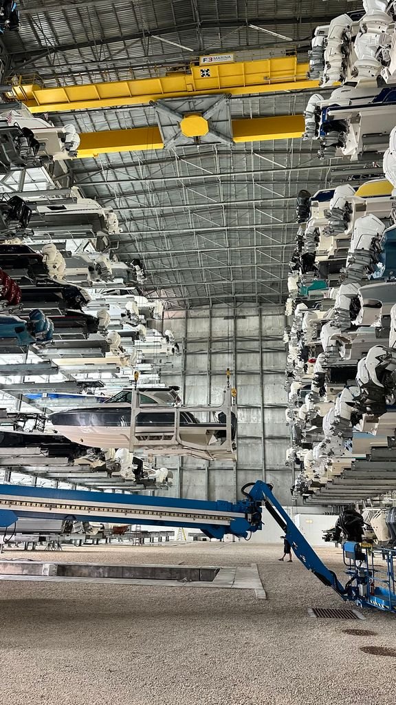 Boats stacked several tiers high on racks inside a covered dry storage building in South Florida