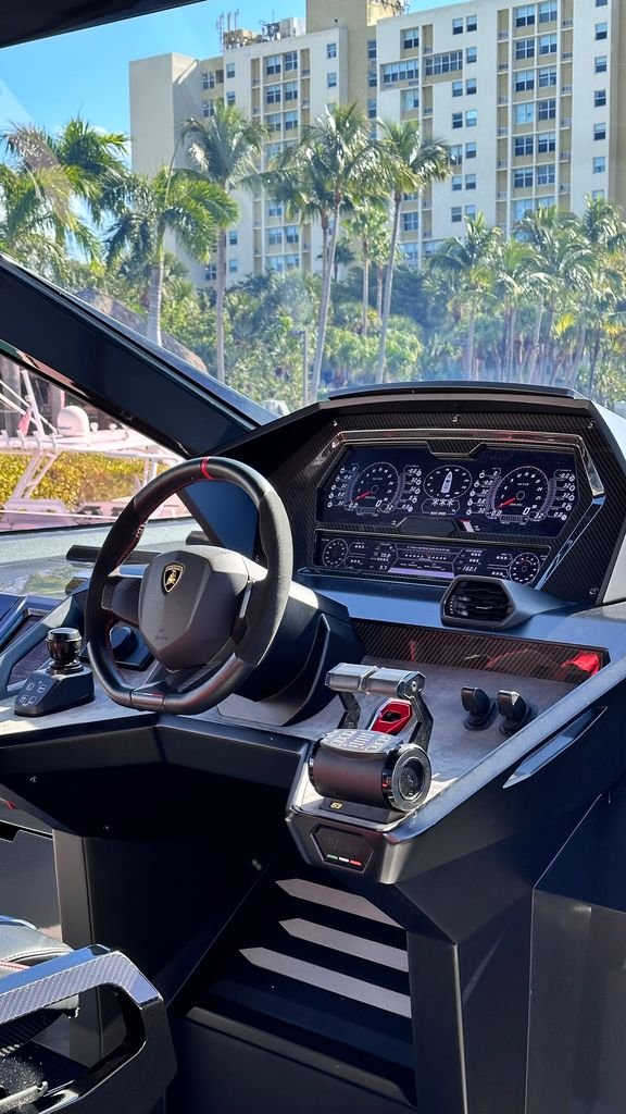Helm console with the screens and throttles powered up during a showing, part of what a yacht broker does on the boat