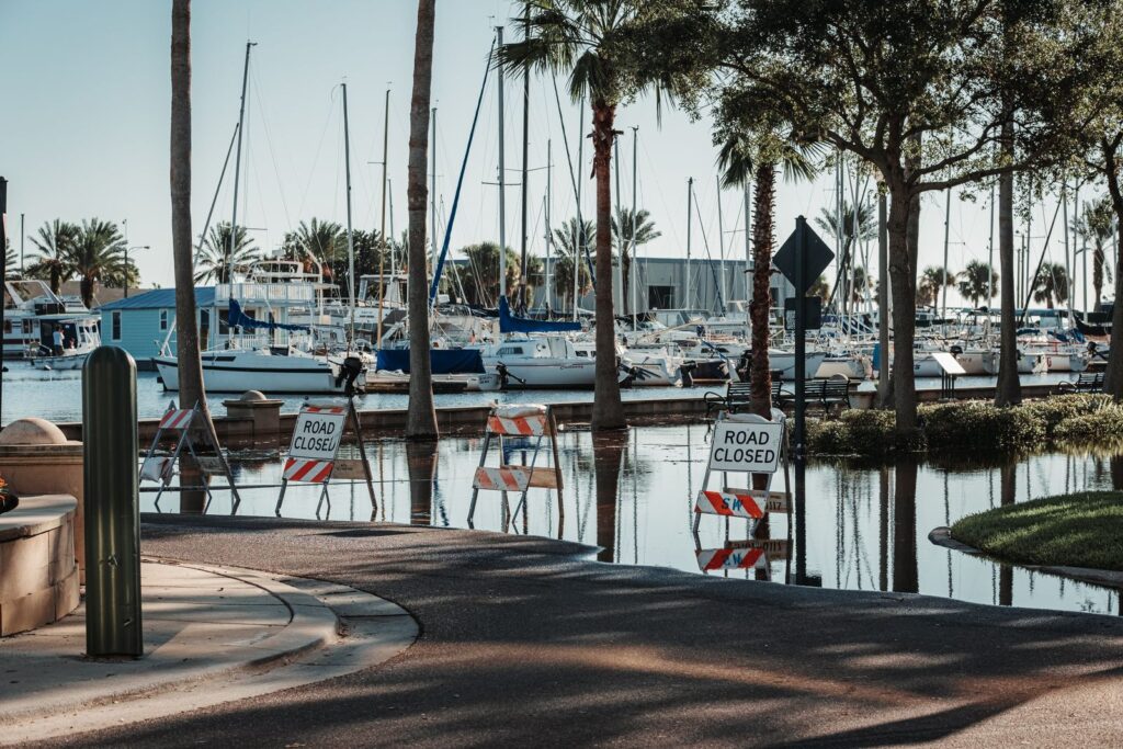 King tides south florida: marina road flooded with water near boat slips