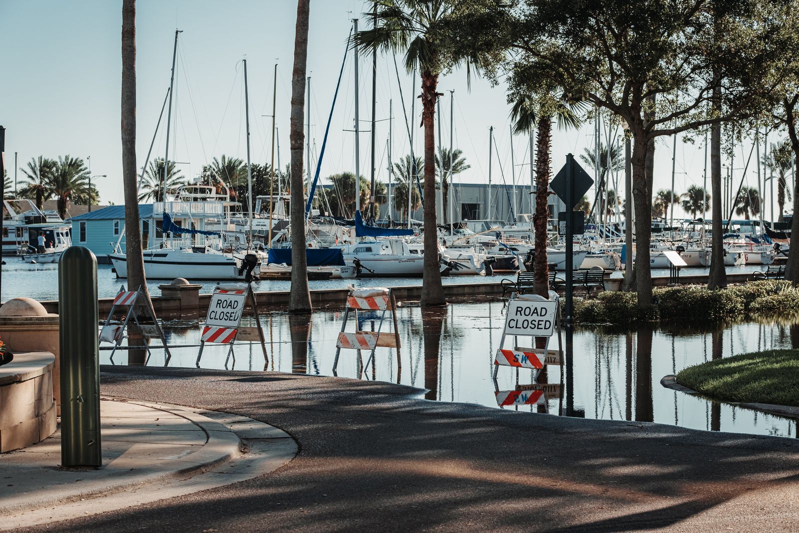 King tides south florida: marina road flooded with water near boat slips